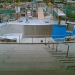 Area prepared; primed, then coating being applied